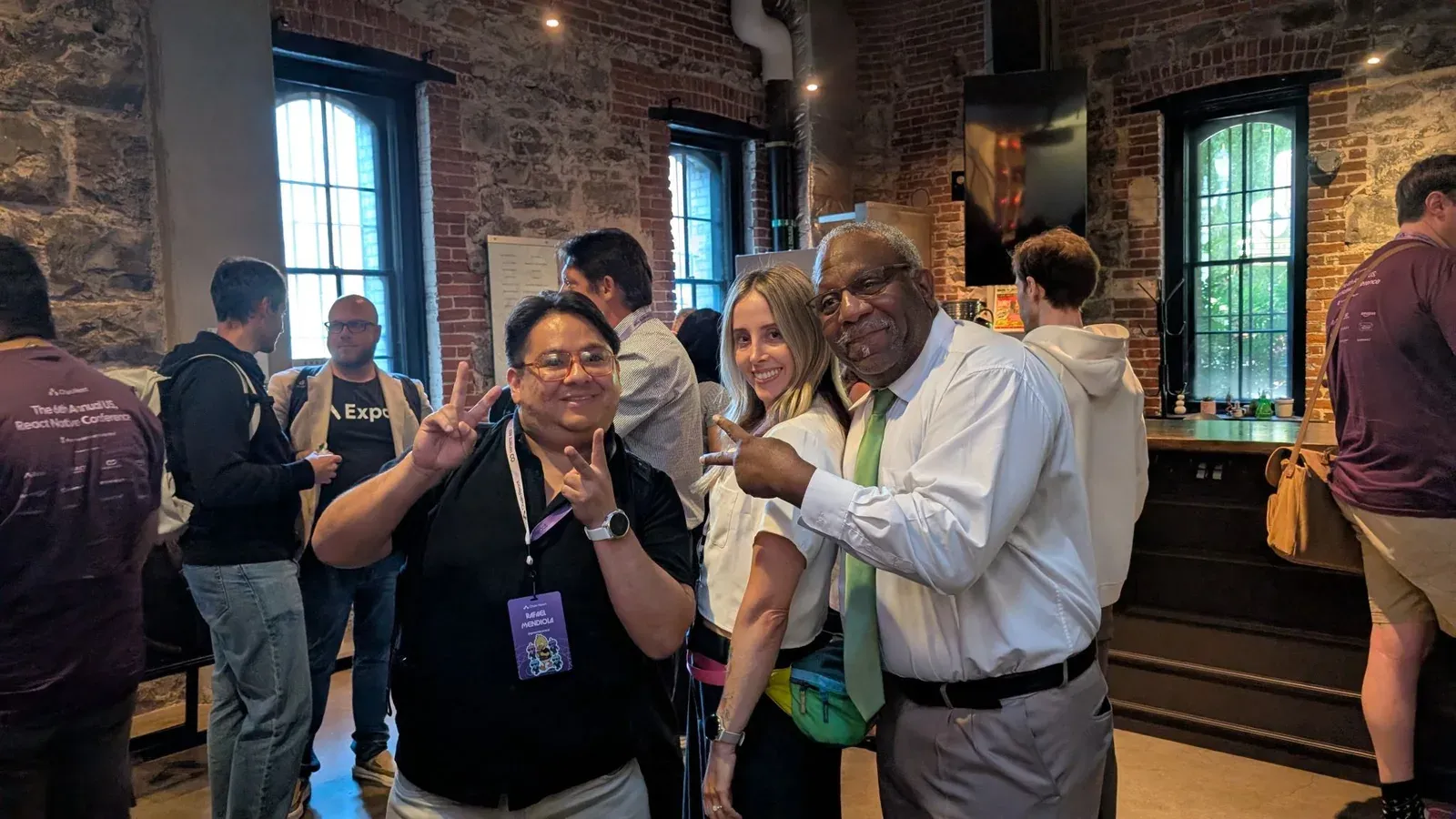 Rafael with two other attendees inside the venue, his Chain React badge visible